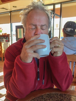 Mike savoring a cup of coffee